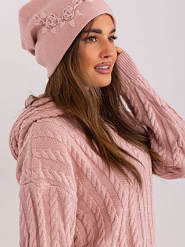 Cap AT  Warm women\'s winter hat made of smooth knit fabric with decorative applique on the side.