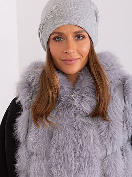 Cap AT  Warm women\'s winter hat made of smooth knit fabric with decorative applique on the side.