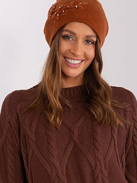 Cap AT  Warm women\'s winter hat made of smooth knit fabric with decorative applique on the side.