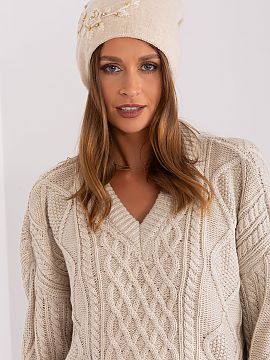 Cap AT  Warm women\'s winter hat made of smooth knit fabric with decorative applique on the side.