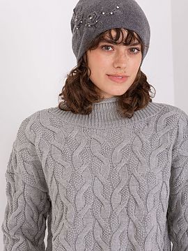 Cap AT   Warm women\'s winter hat made of smooth knit fabric with decorative applique on the side.
