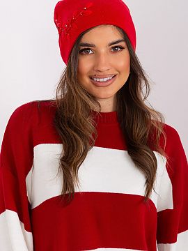 Cap AT  Warm women\'s winter hat made of smooth knit fabric with decorative applique on the side.