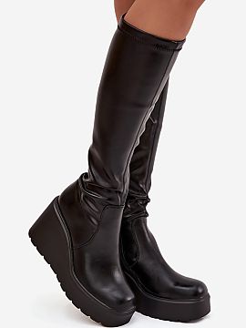 Wedge boots Step in style  Women\'s boots made of eco-leather are an elegant and stylish proposition for colder days. The slip-on model with an additional zipper at th