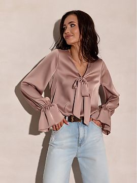 Blouse Roco Fashion  Elegant blouse with a loose fit, V-neckline and decorative bow at the neck. Slightly flared cuffs add lightness and subtle femininity, while
