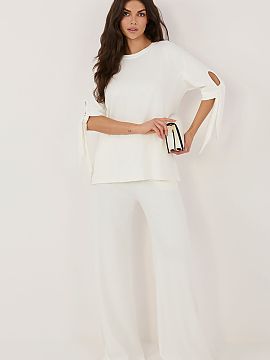 Complete Relevance  A women\'s set consisting of a blouse and trousers is a comfortable and stylish proposition for everyday wear and work. Made of soft and ple