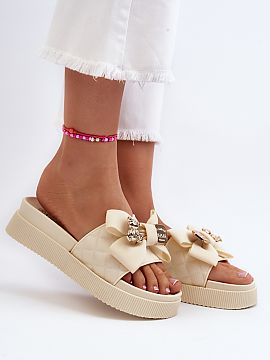 Platform sandals Step in style  Women\'s flip flops made of eco leather. Set on a massive platform. This model has a fabric bow and an imitation of a clasp with a teddy bea
