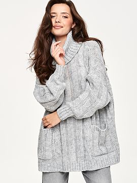 Turtleneck Makadamia  Oversize women\'s sweater is a perfect choice for cooler days. The model stands out with a high, wide turtleneck that elegantly wraps around