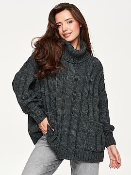 Turtleneck Makadamia  Women\'s oversized sweater is a perfect choice for cooler days. The model stands out with a high, wide turtleneck that elegantly wraps aroun