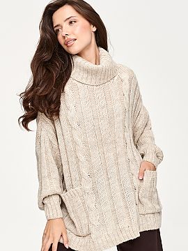Turtleneck Makadamia  Oversize women\'s sweater is a perfect choice for cooler days. The model stands out with a high, wide collar that elegantly wraps around the