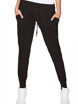 Tracksuit trousers Tessita  Comfortable loose-fitting trousers made of cotton fabric. At the bottom finished with a welt. Waistband with rubber band at the top of the t