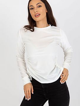 Blouse Lakerta  Short velour blouse with long sleeves and a round neckline. On the sides there are ties to adjust the length.