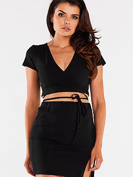 Short skirt Infinite You  Mini skirt on a thick elastic waistband. It has two decorative vertical seams on the front. Small slit on the left leg. Designed and sewn in