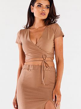 Short skirt Infinite You  Mini skirt on a thick elastic waistband. It has two decorative vertical seams on the front. Small slit on the left leg. Designed and sewn in