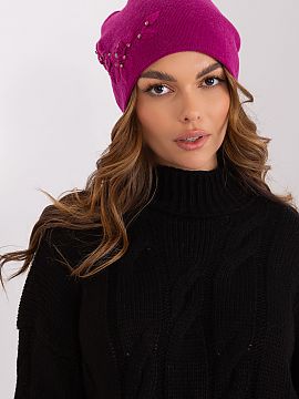Cap AT  Warm women\'s winter hat made of smooth knit fabric with decorative applique on the side.
