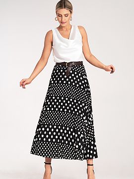 Skirt Figl  Pleated midi skirt, decorated with a white polka dot pattern. High-waisted model with subtle pleats and a stylish belt with a buckle, emphas