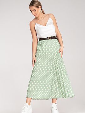 Skirt Figl  Pleated midi skirt, decorated with a white polka dot pattern. High-waisted model with subtle pleats and a stylish belt with a buckle, emphas