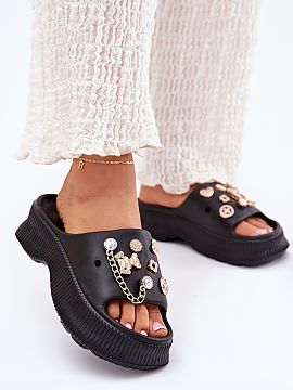 Flip-flops Step in style  Women\'s flip flops made of foam material, set on a platform, are a stylish choice for warm days. Golden, charming pins on the strap give th