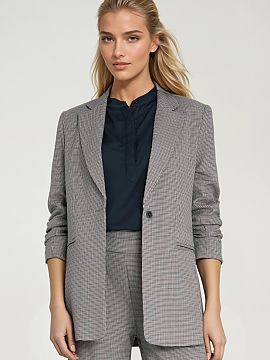 Jacket Nife  Stylish women\'s jacket with a loose regular fit, made of material in a small houndstooth pattern. The model features classic, lapel collar 