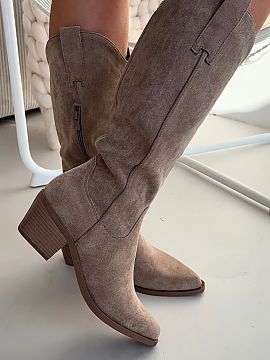 Heeled boots Step in style  Cowgirl boots made of eco-suede are a stylish model inspired by a western accent. Set on a characteristic, beveled heel, they emphasize the 