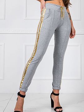 Tracksuit trousers BFG  Women\'s sweatpants with an elastic waistband and binding. Pants with decorative contrasting stripes on the sides and slip pockets.