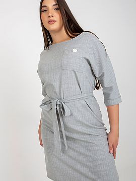 Plus size dress Lakerta  A plus size pencil cut dress with 3/4 sleeves and a round neckline. There is a tie belt at the waist. The dress is made of striped fabric.